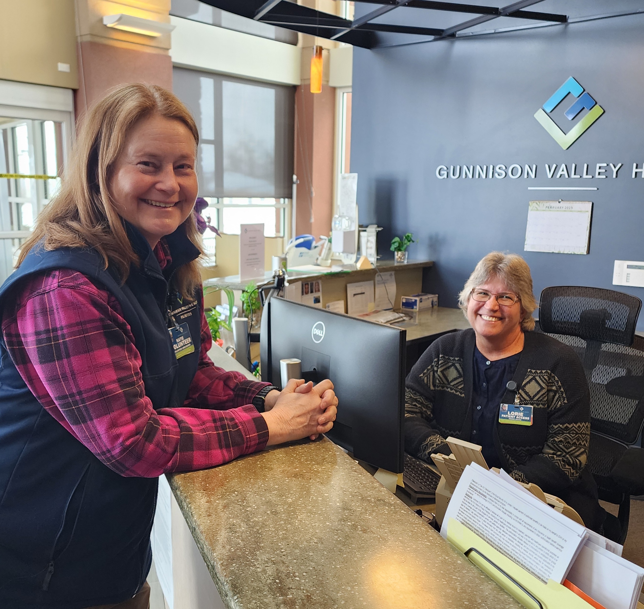An ambassador for GVH posses with our front desk staff at the north entrance