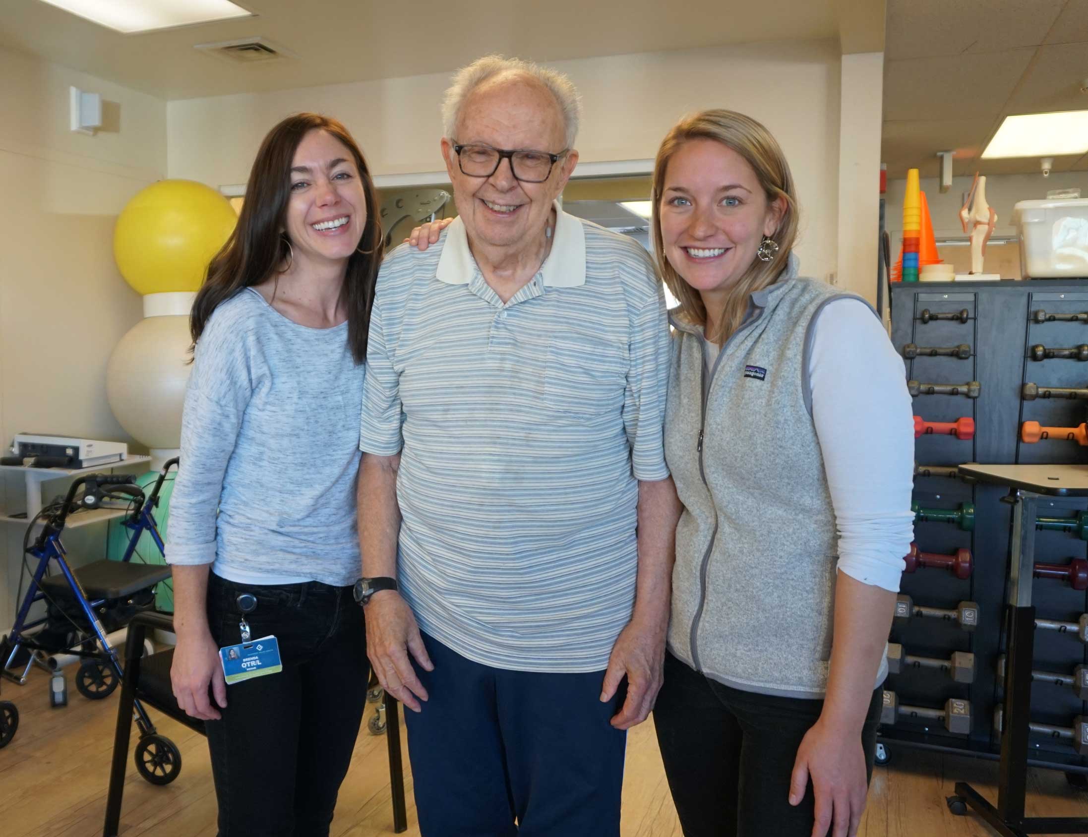 nurses posing with senior patient