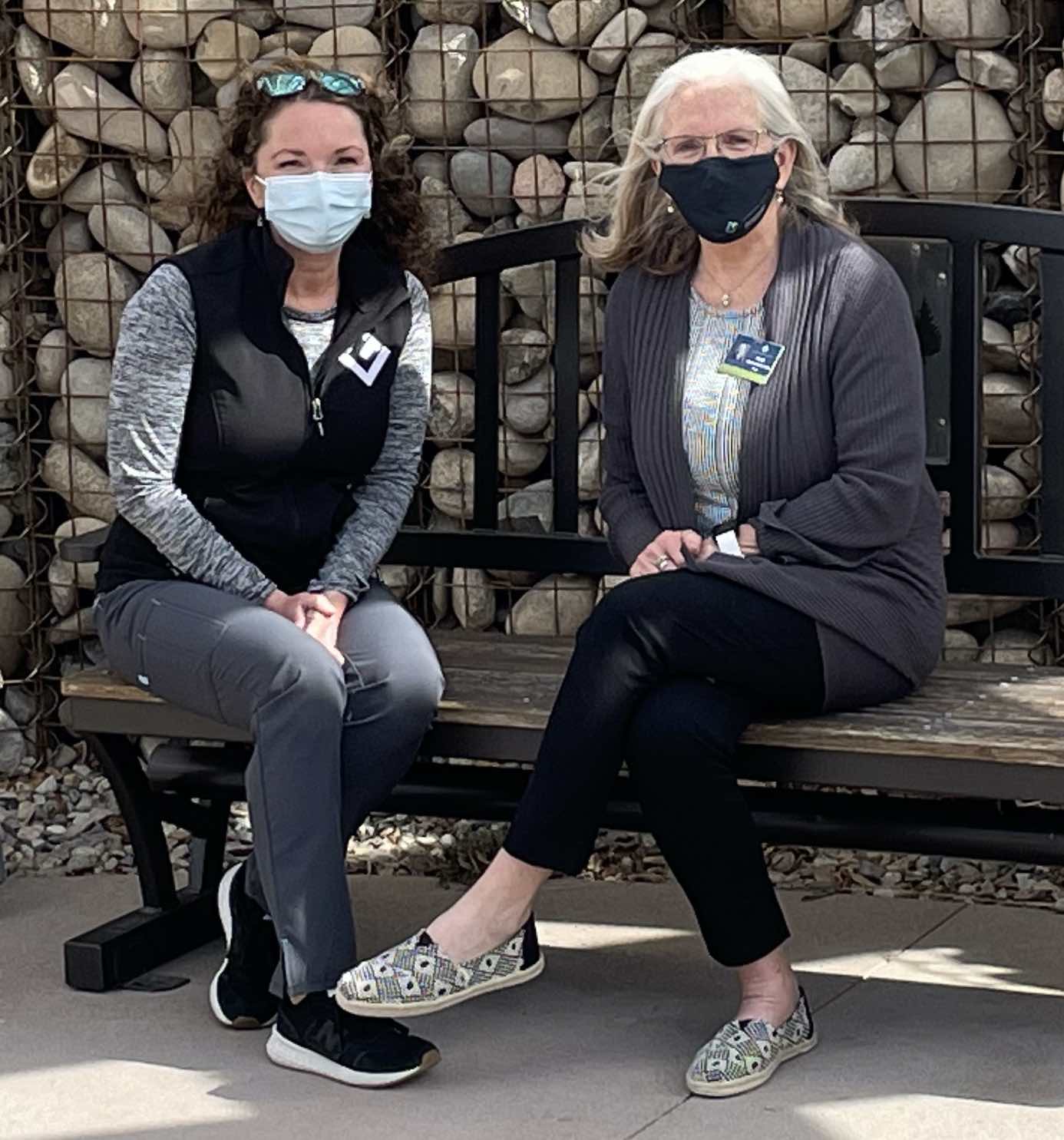 two women with masks on